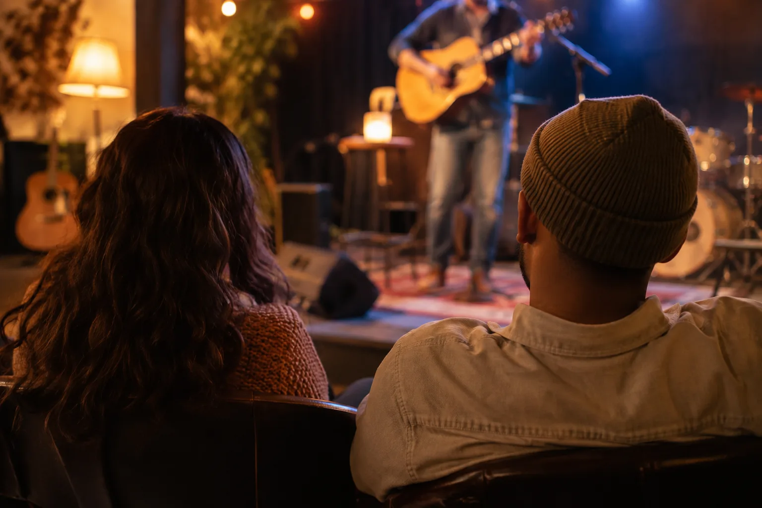 A cozy local music venue in Provo with a small stage, warm lights, instruments, and an attentive audience.